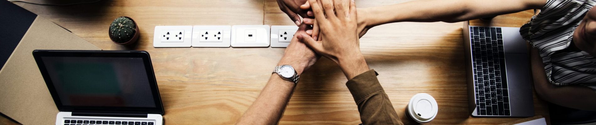 Team of business people stacking hands