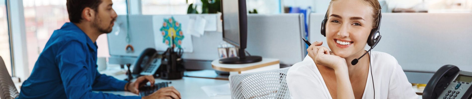 Young beautiful female support phone operator speaking, consulting, office background.